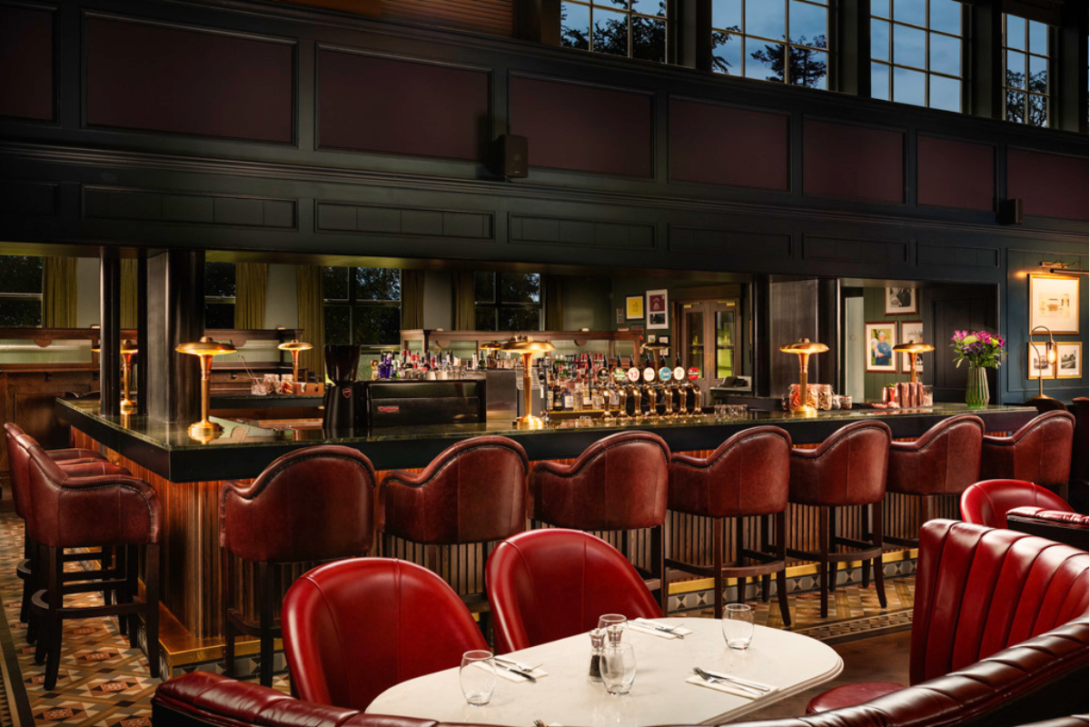 a restaurant with a bar and chairs