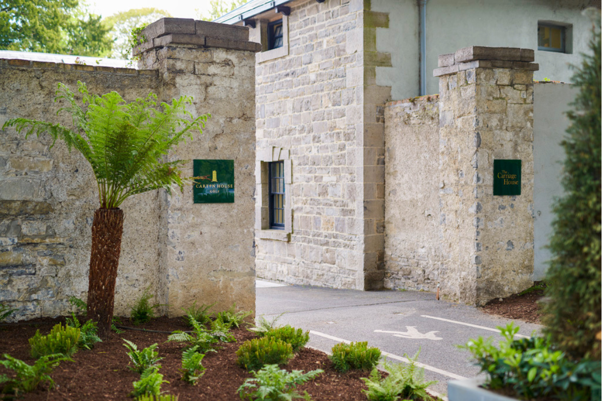 a stone wall with a sign on it