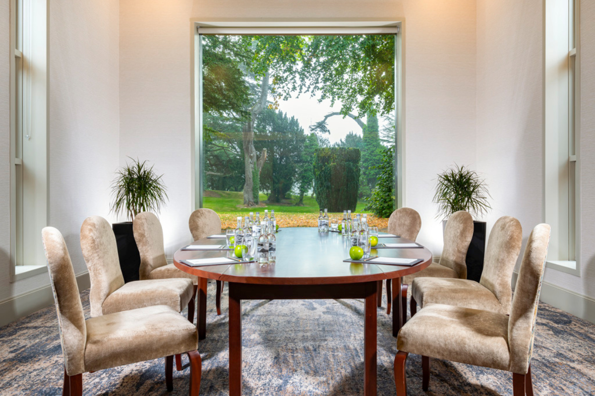 a table with chairs and a large window