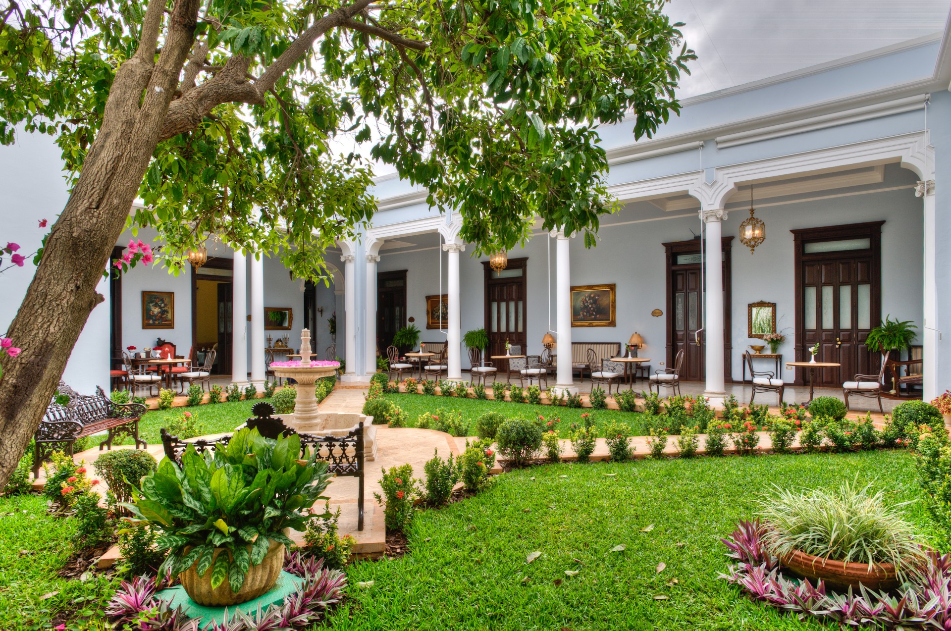 a courtyard with a fountain and a fountain in front of it