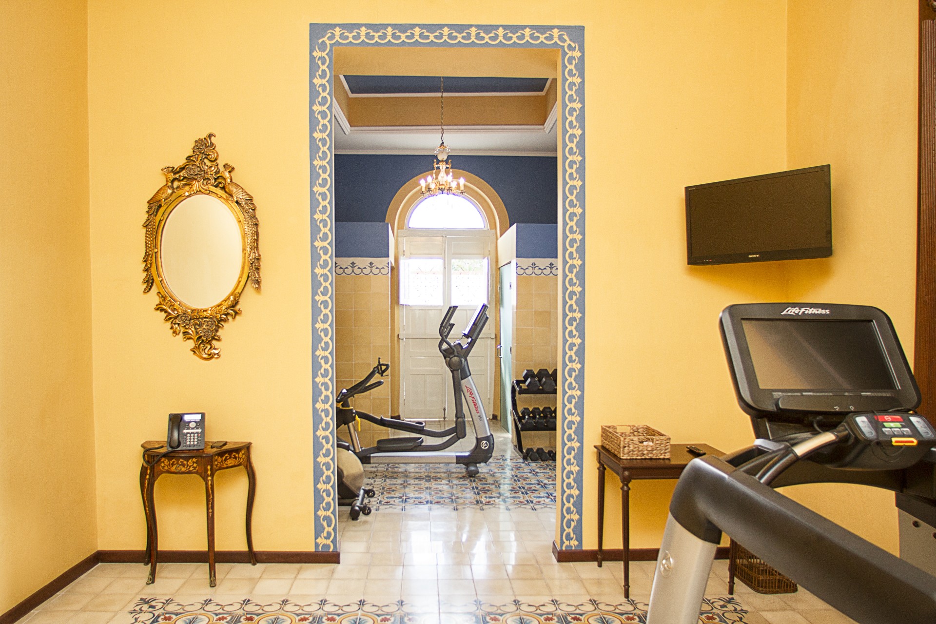 a room with exercise equipment and a mirror