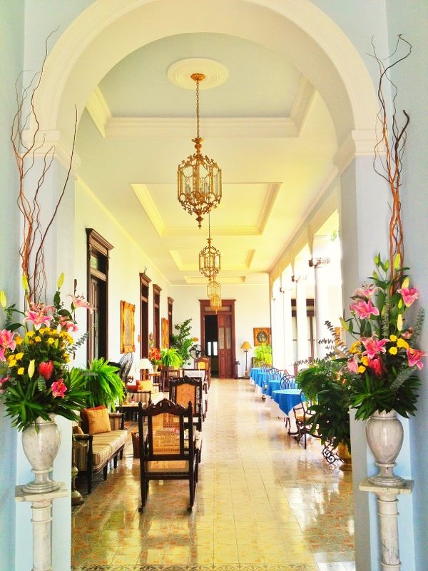 a long hallway with chairs and flowers