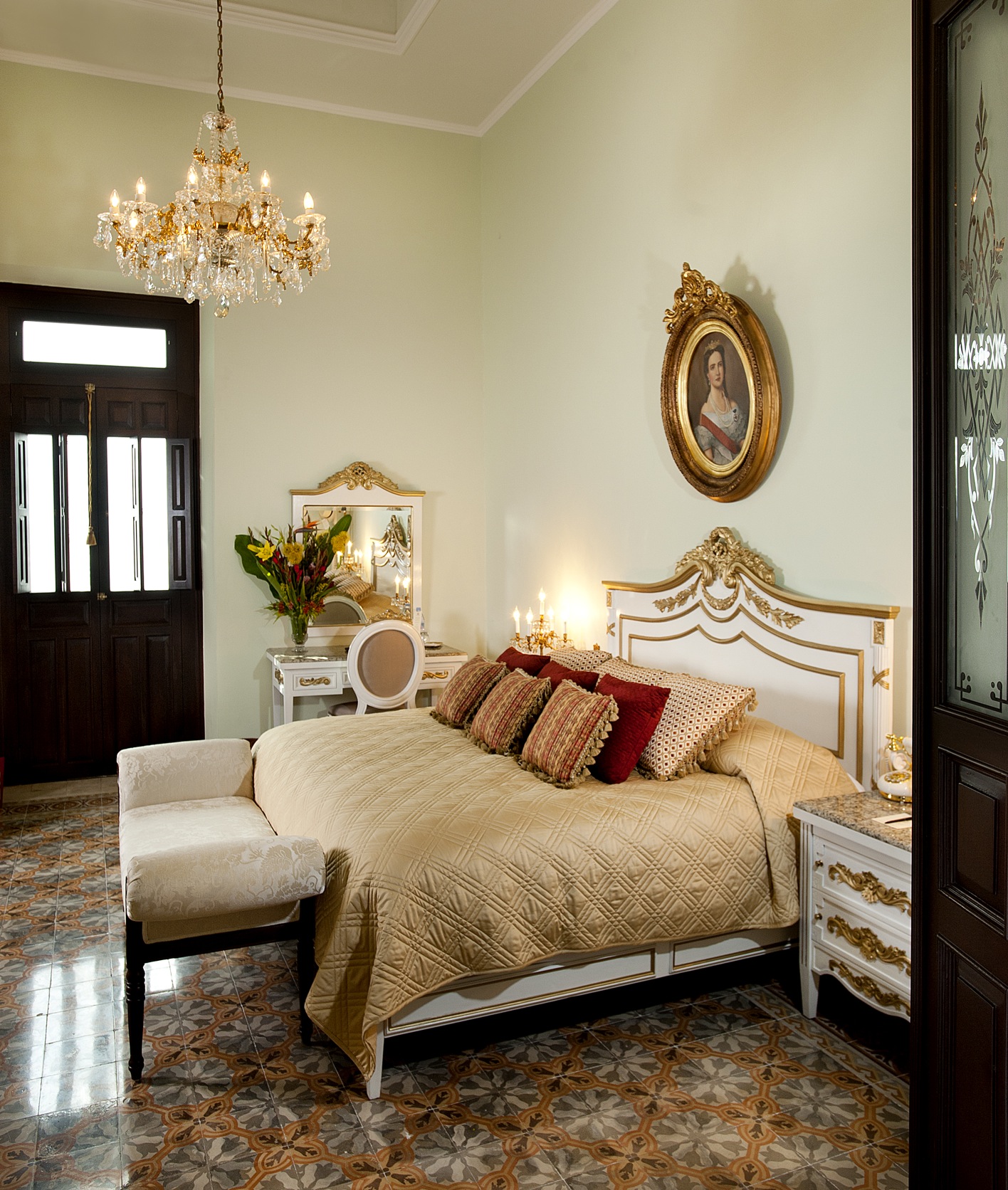 a bedroom with a bed and chandelier