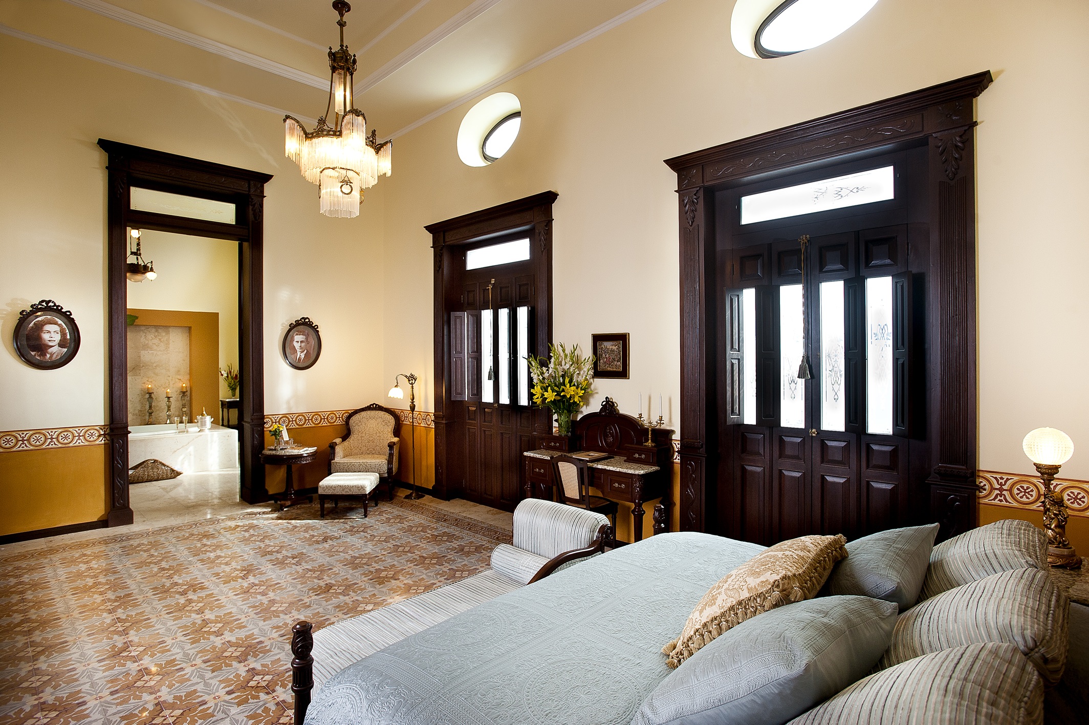 a bedroom with a bed and a chandelier