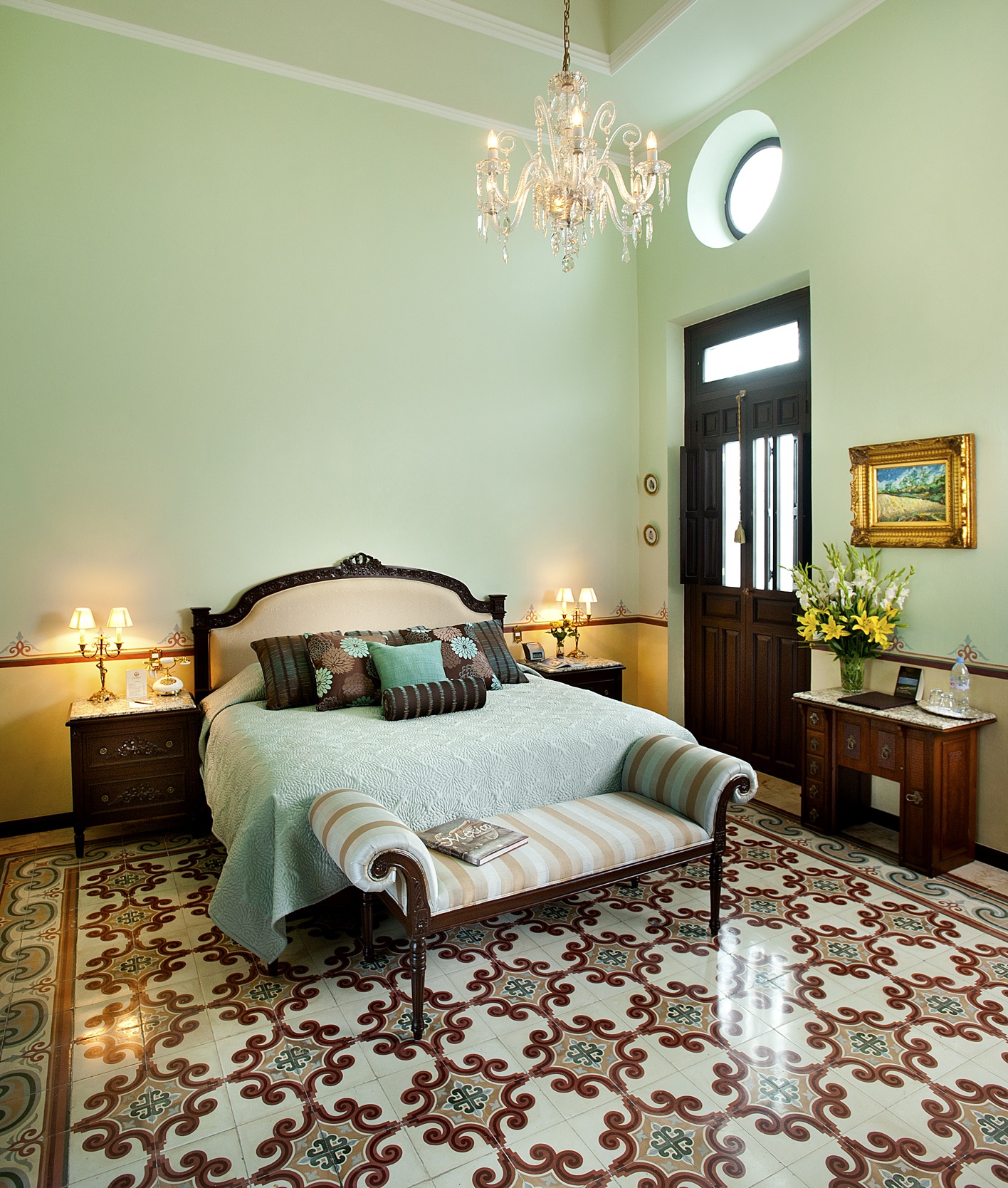 a bedroom with a bed and a chandelier