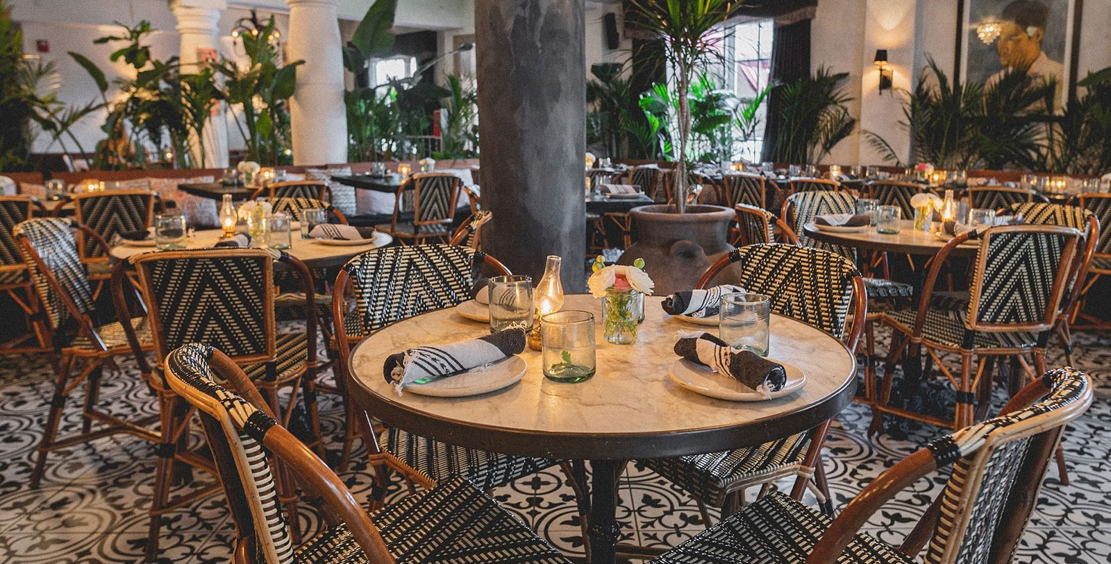 a table with chairs and candles