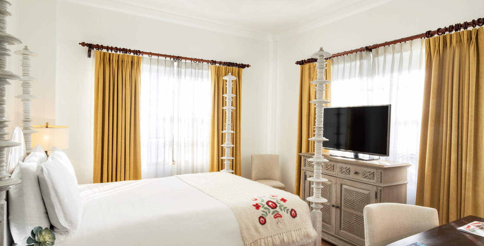 a bedroom with a tv and a bed
