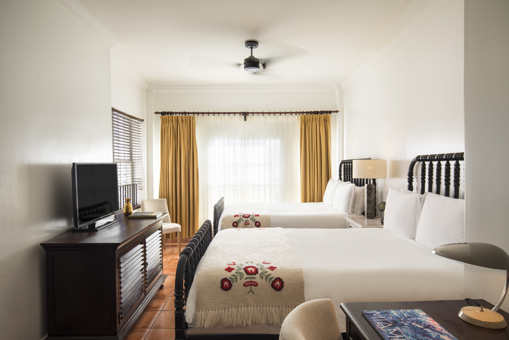 a room with two beds and a tv