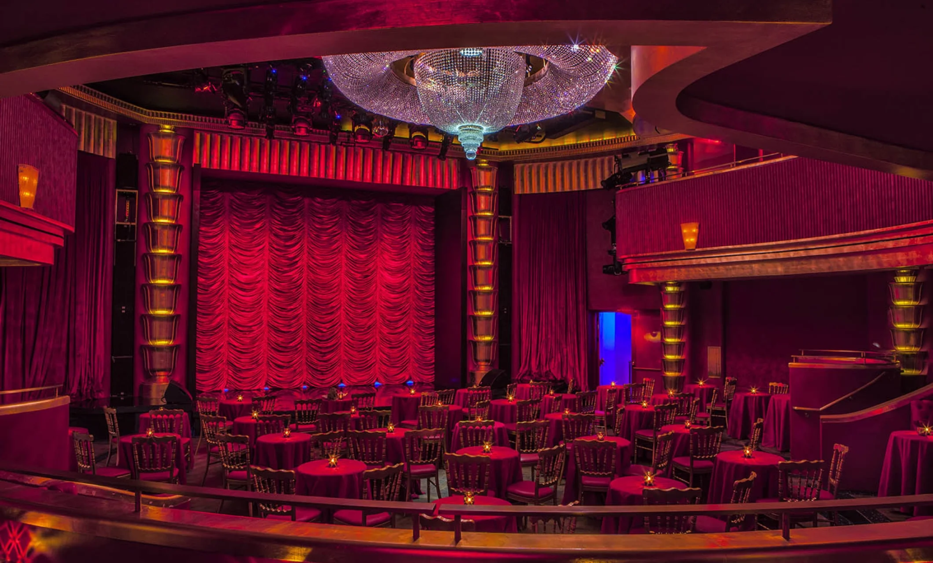 a room with red curtains and tables and chairs
