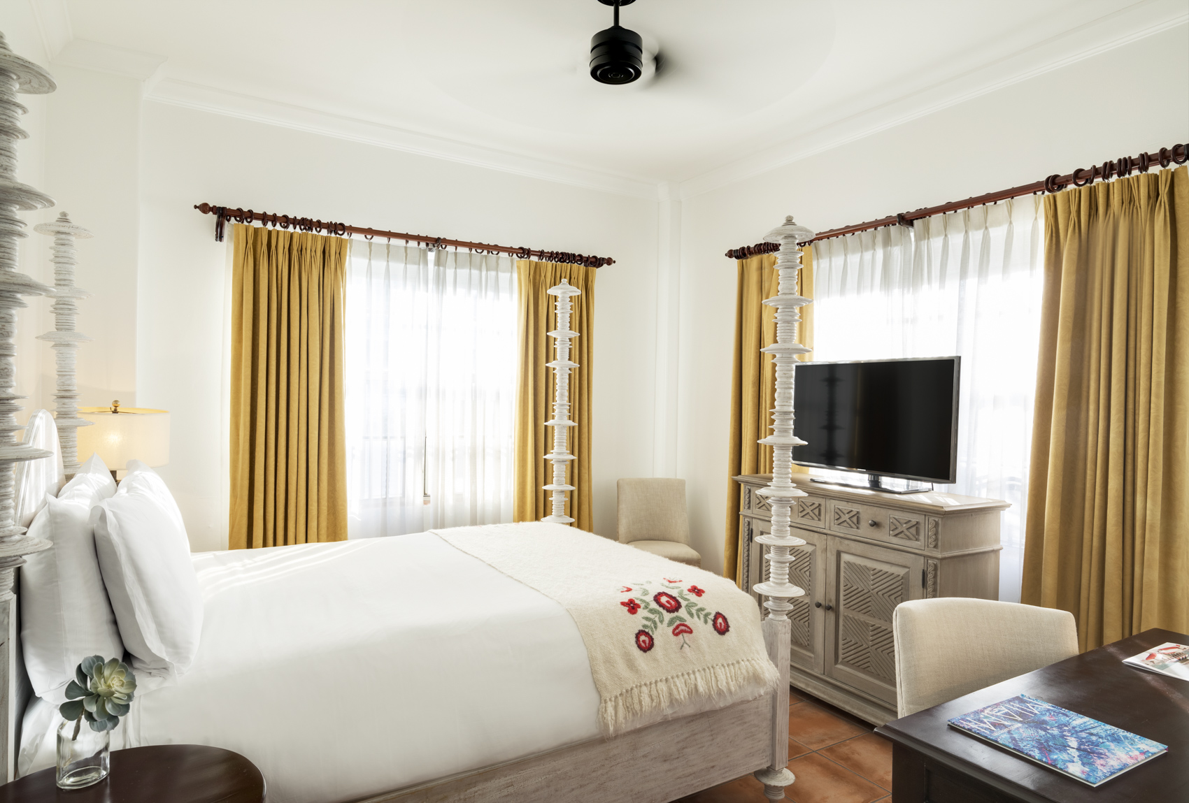 a bedroom with a bed and a tv