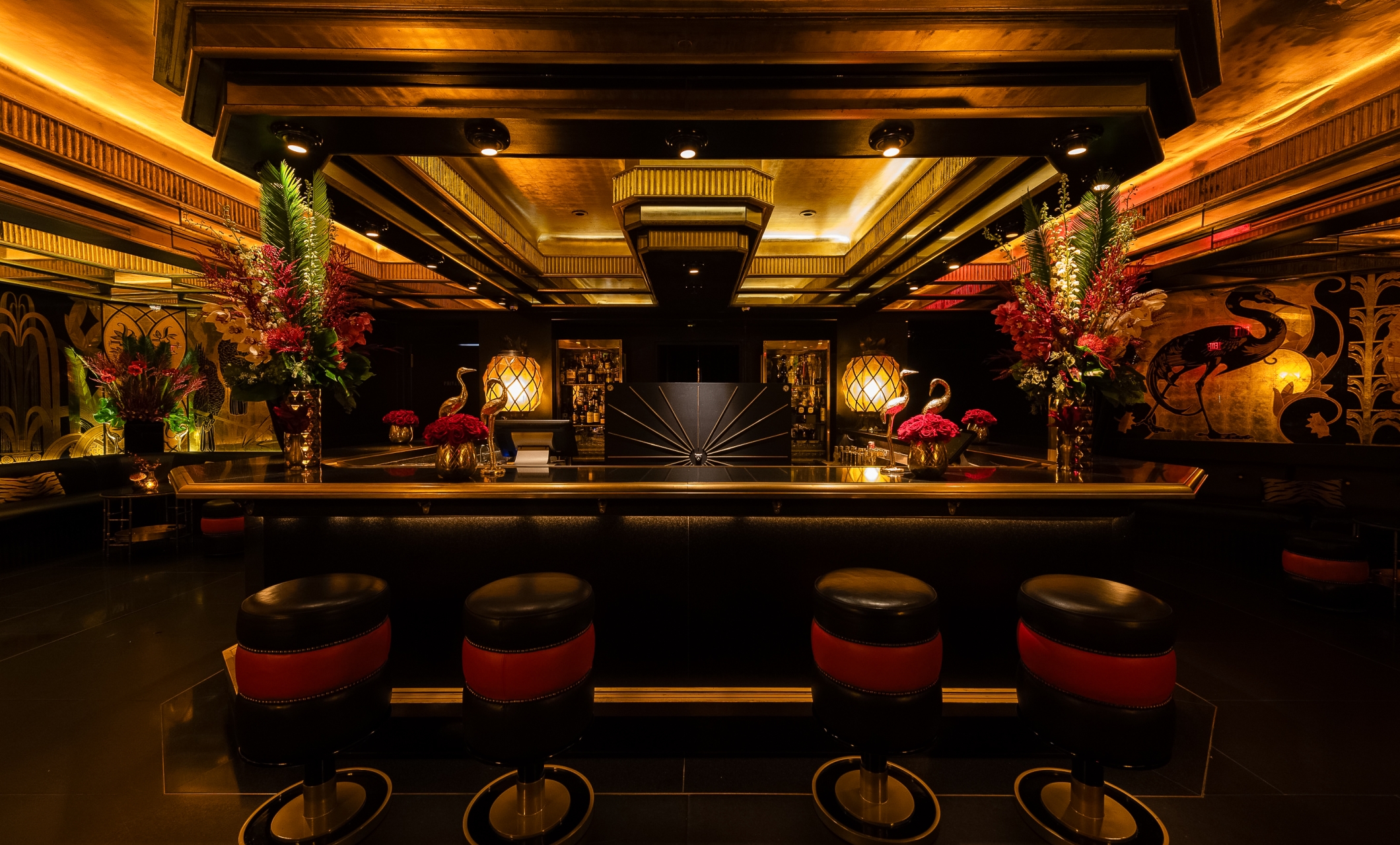 a bar with chairs and flowers