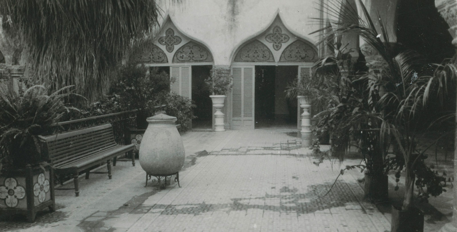 a stone pot in front of a building