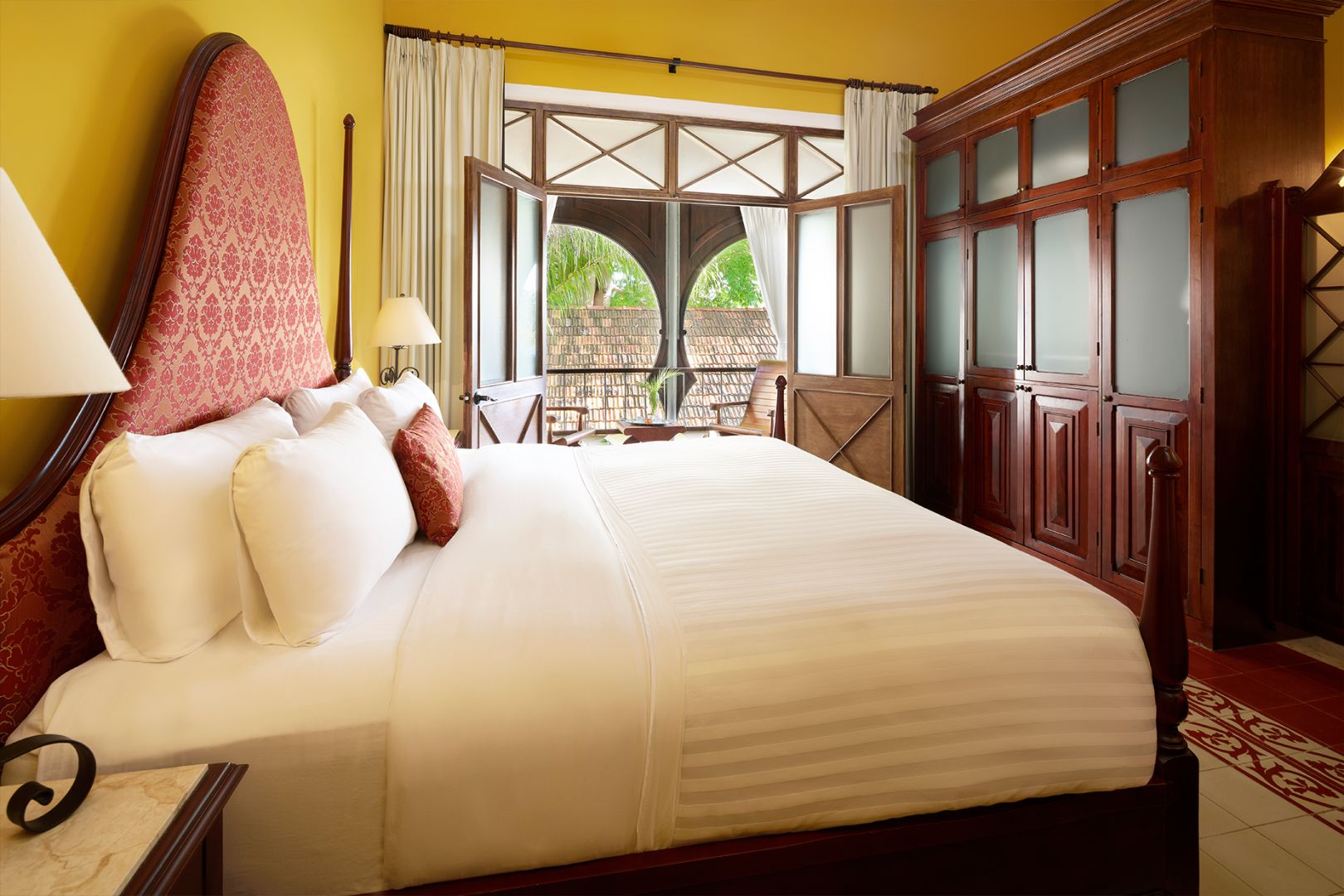 a bed with a large headboard and a large window
