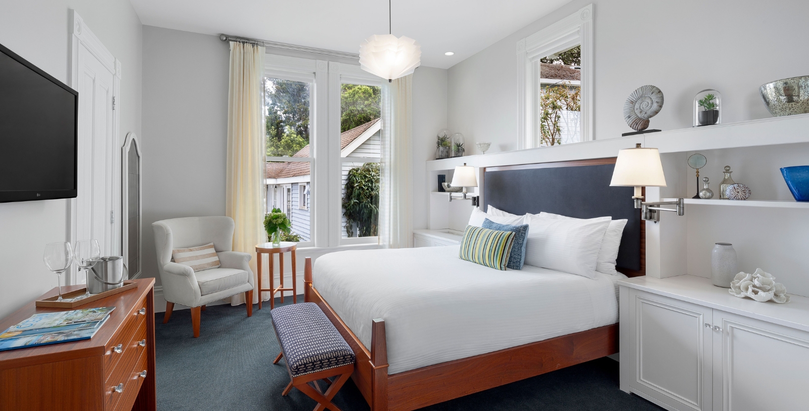 a bedroom with a bed and chairs