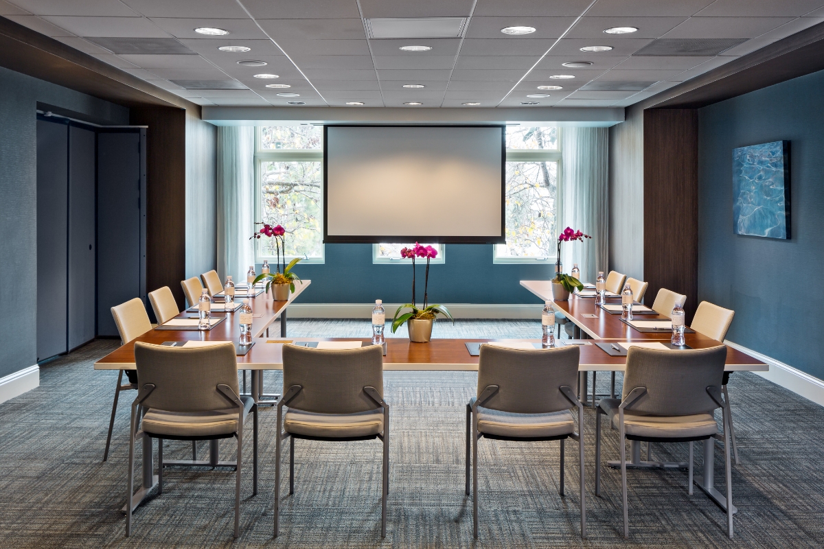 a conference room with a projector screen