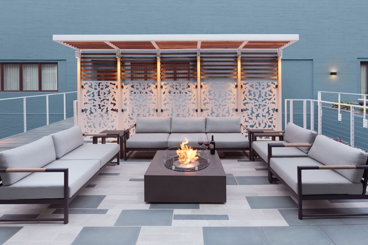 a patio with a fire pit and couches