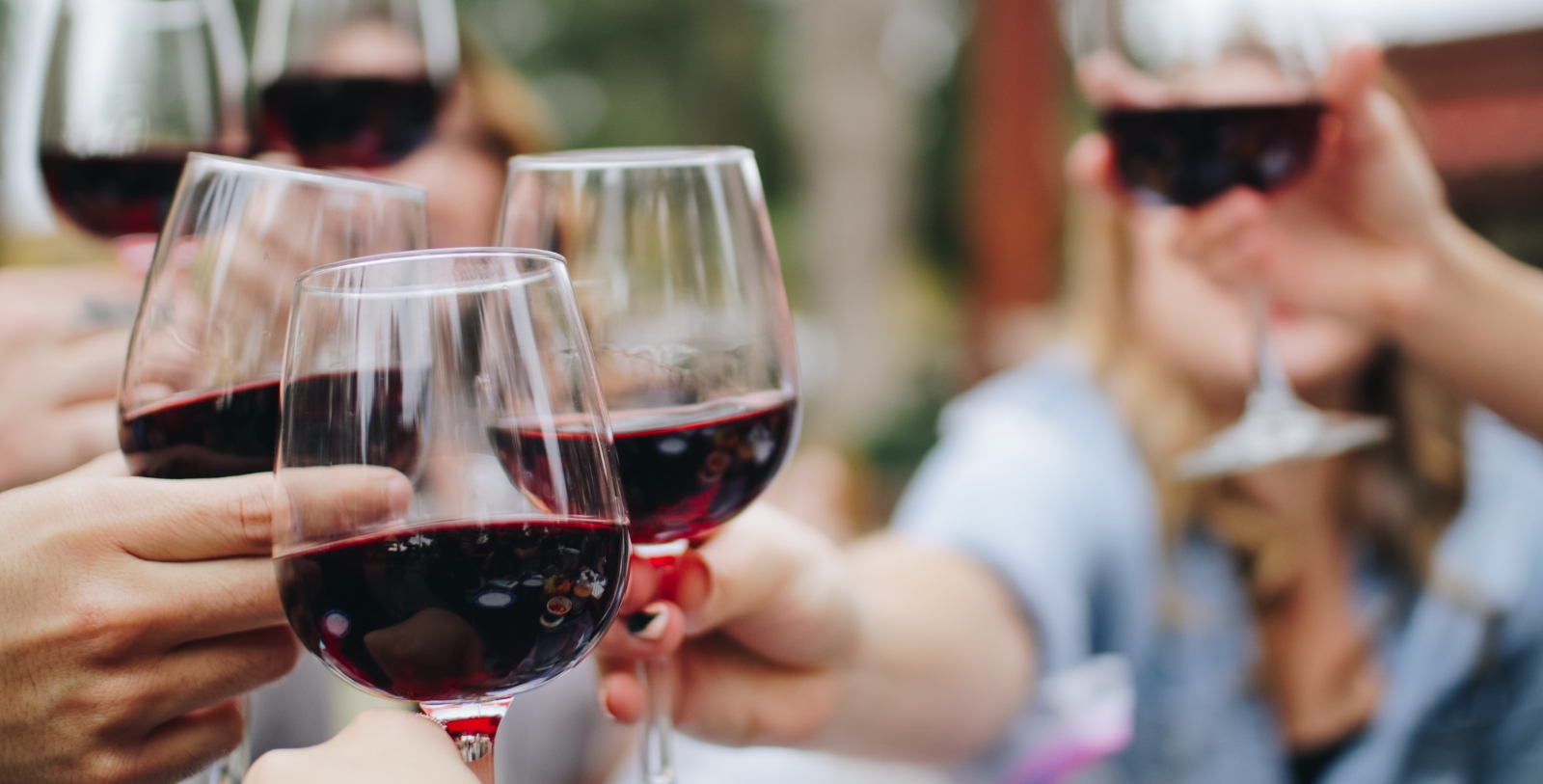 a group of people holding wine glasses
