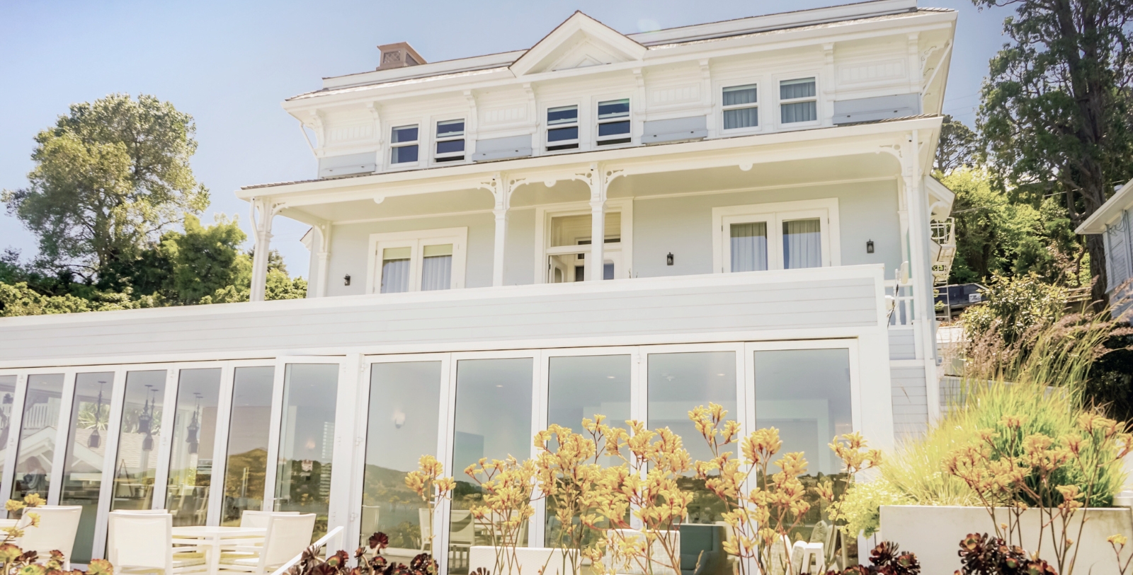 a large white house with glass doors