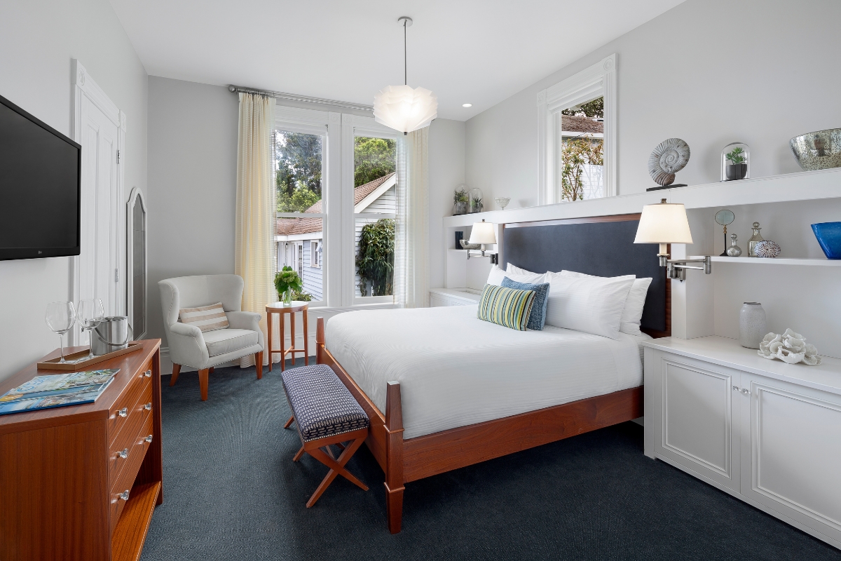 a bedroom with a bed and a television