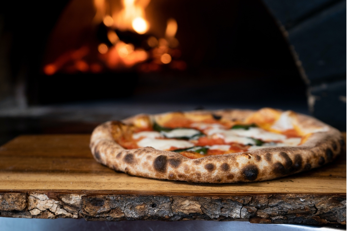 a pizza on a wood board