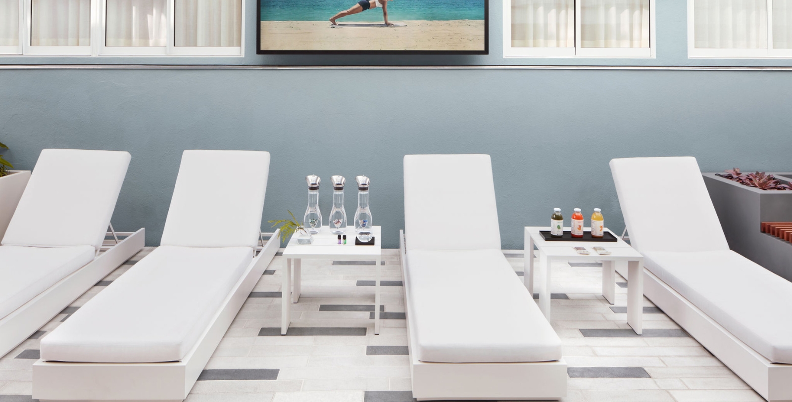 a lounge chairs and a table with drinks on it