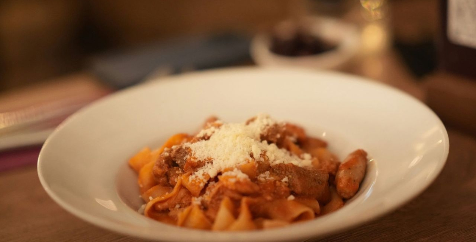a plate of pasta with grated cheese
