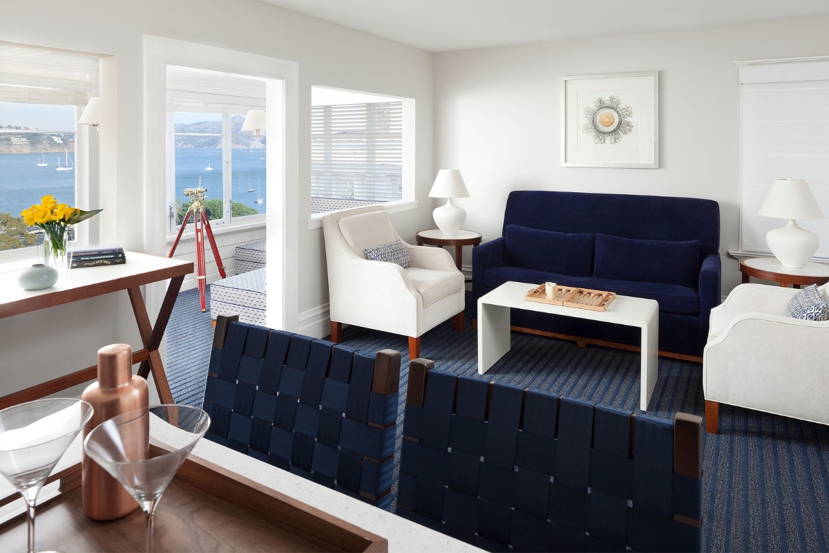 a room with a couch and chairs