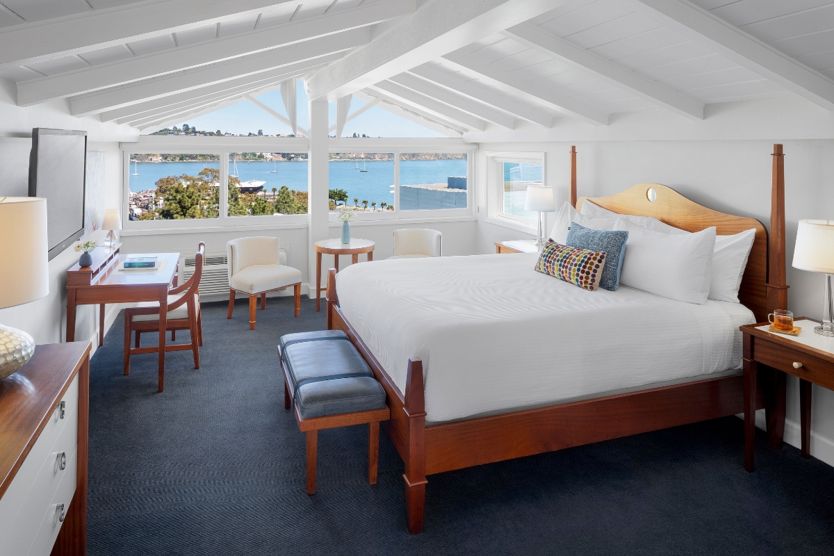 a room with a bed and chairs and a table