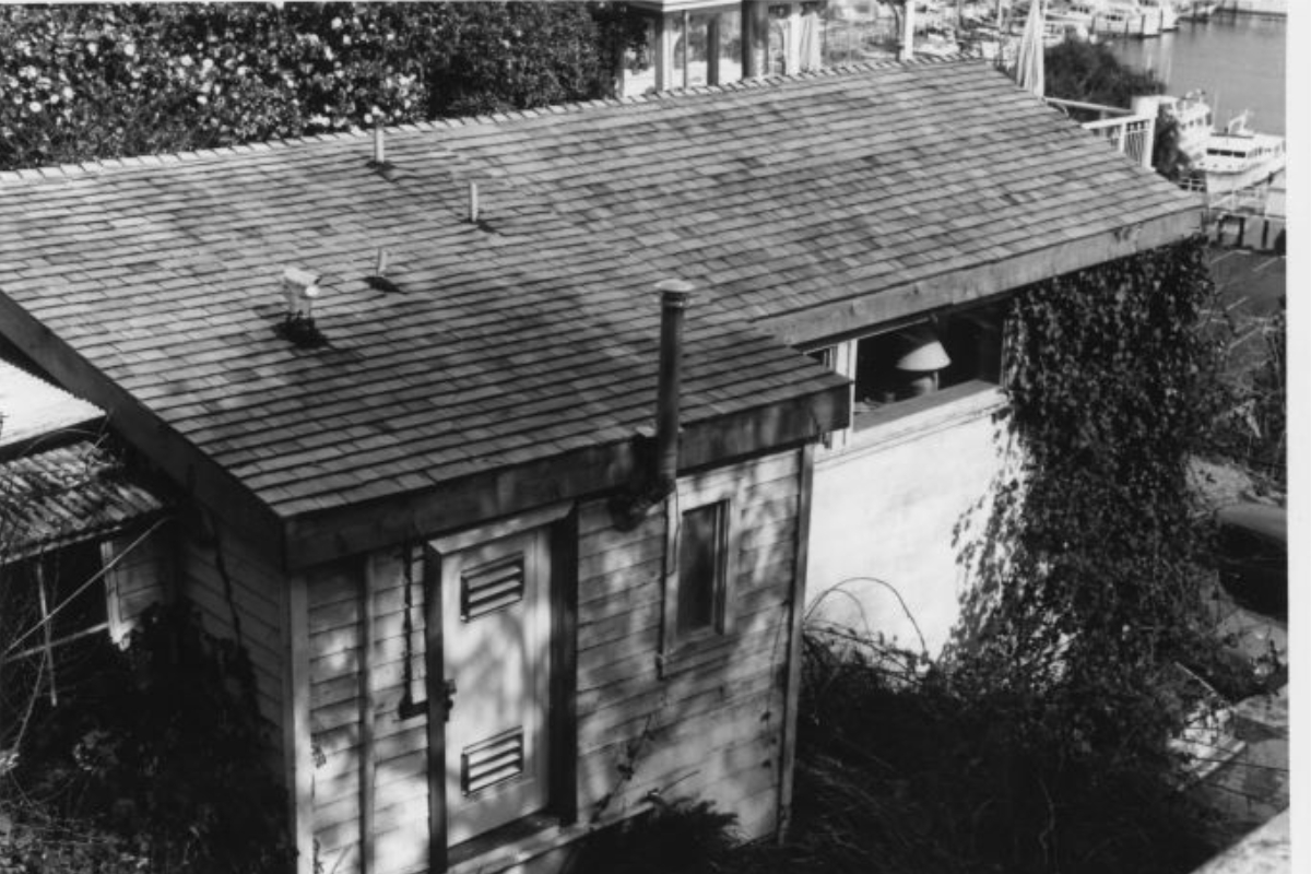 a small wooden building with a chimney