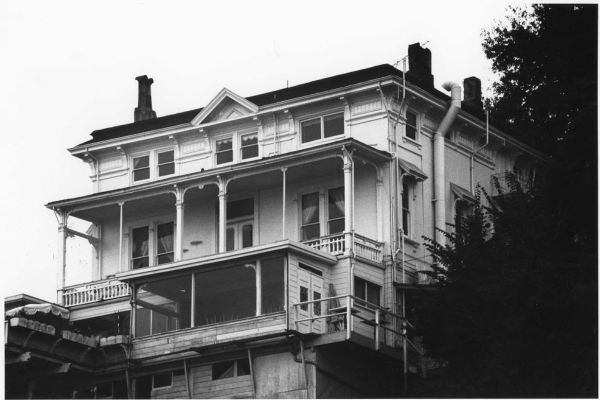 a large white house with a black roof