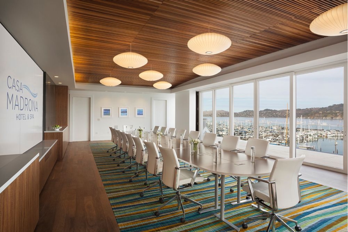 a room with a long table and chairs