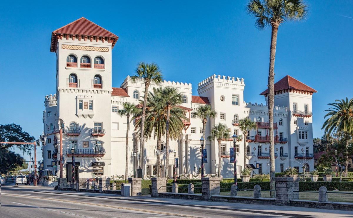 a white building with palm trees