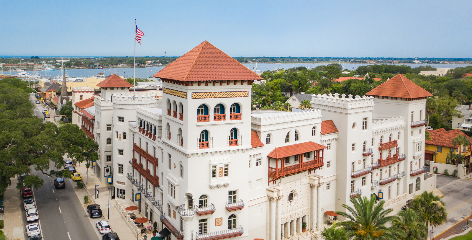 a white building with a flag on the roof