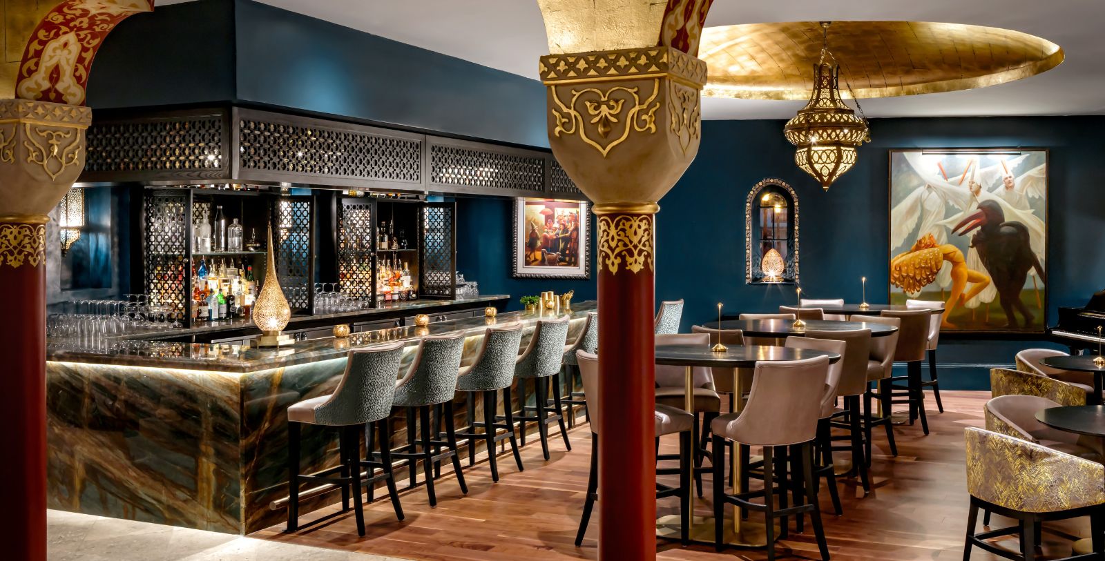 a room with a bar and chairs