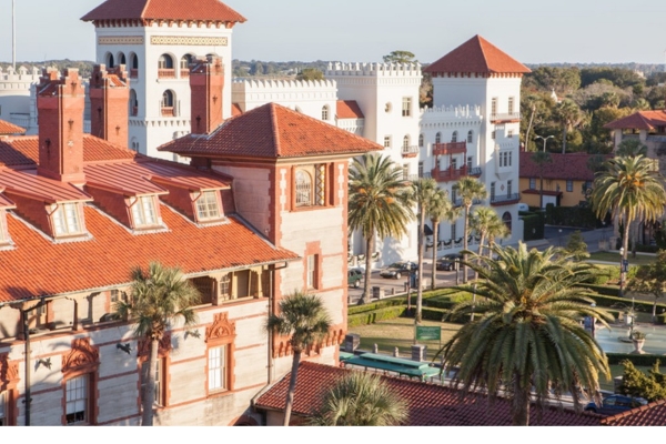 a group of buildings with palm trees