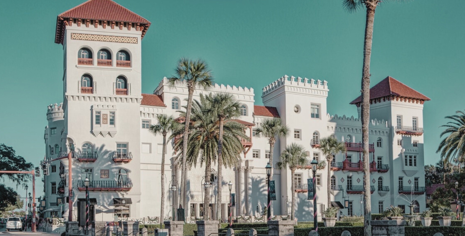 a white building with palm trees