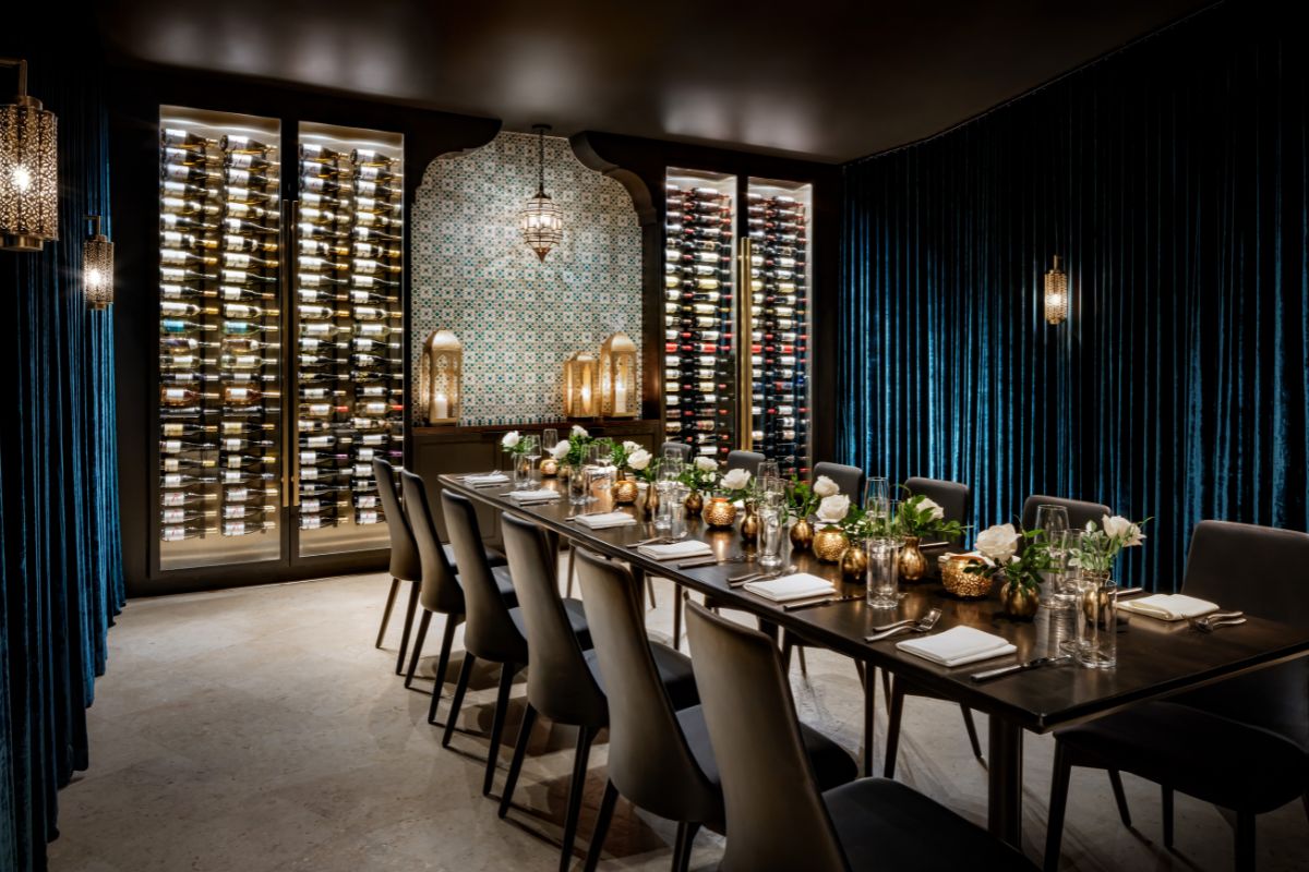 a long table with wine bottles in the back