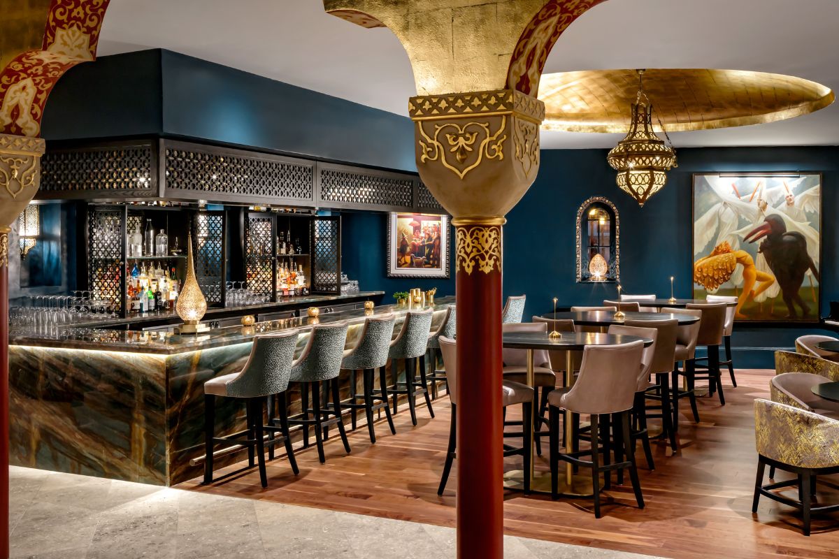 a bar with a row of tables and chairs
