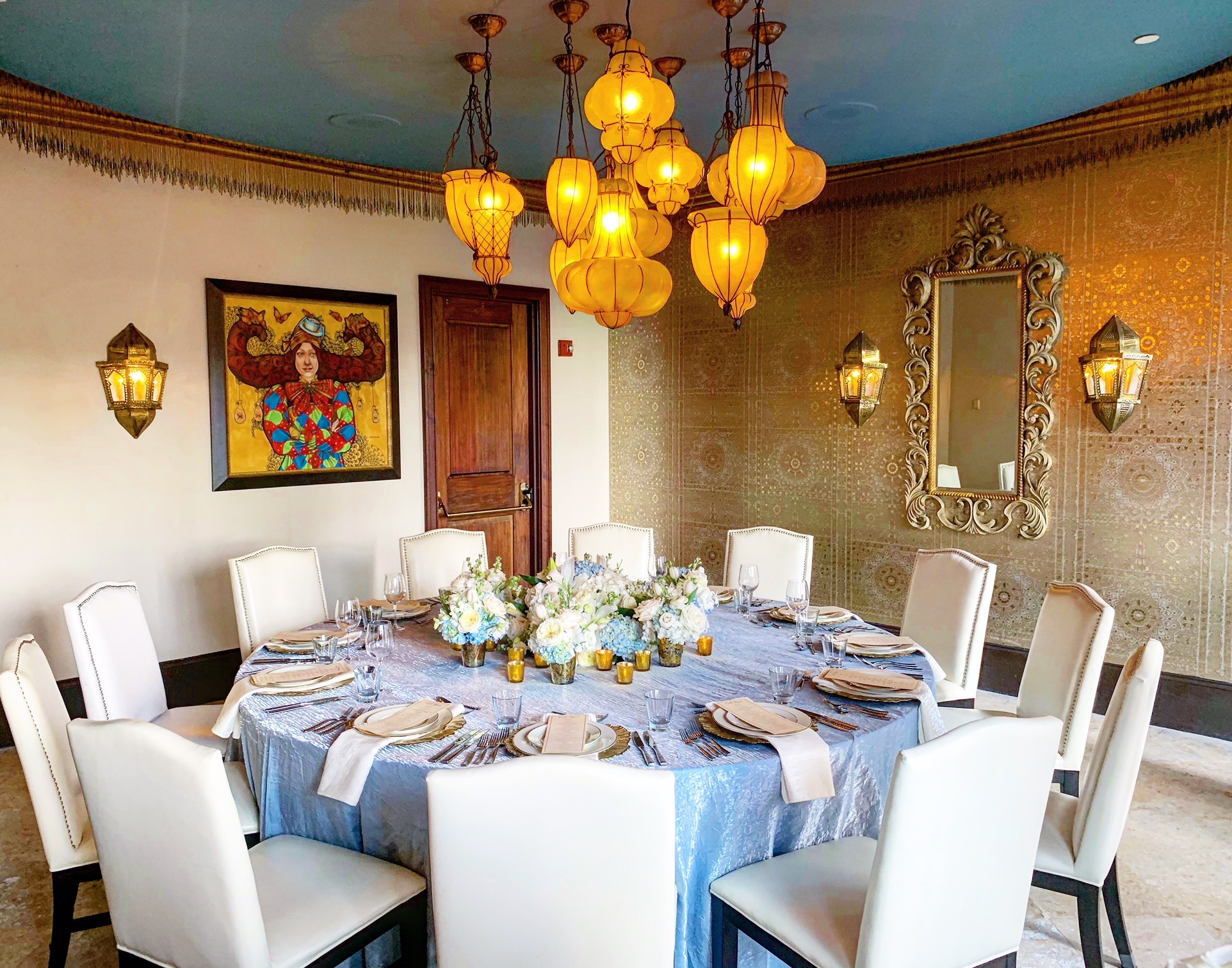 a round table with plates and flowers on it