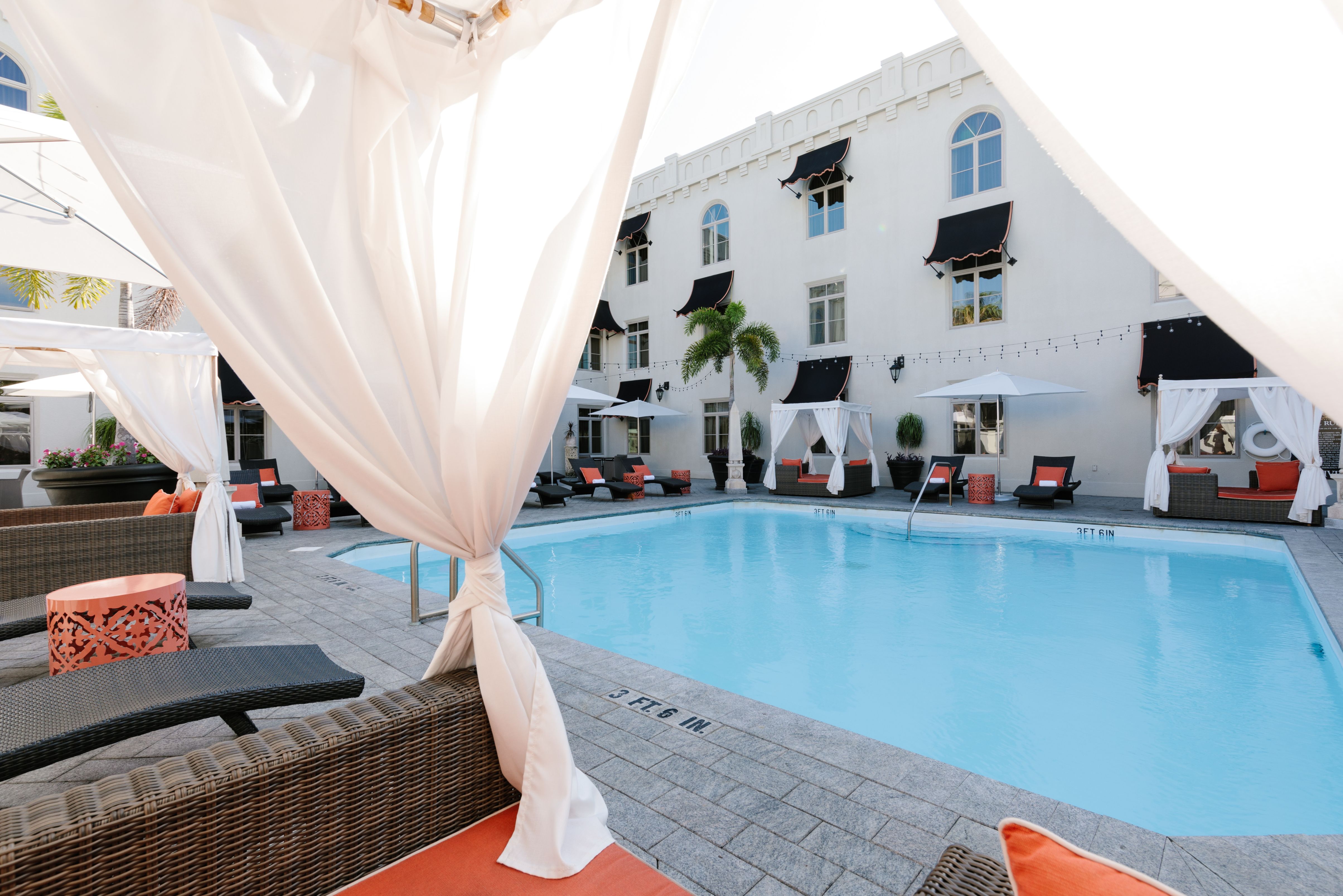 a pool with a white curtain