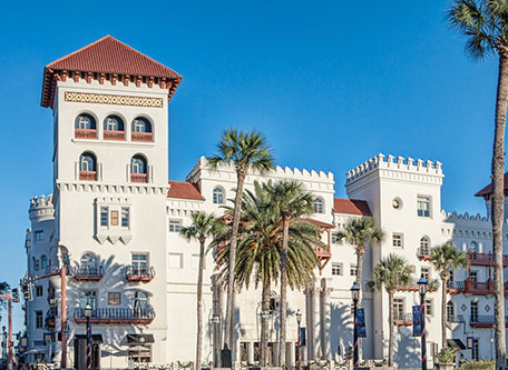 a white building with palm trees