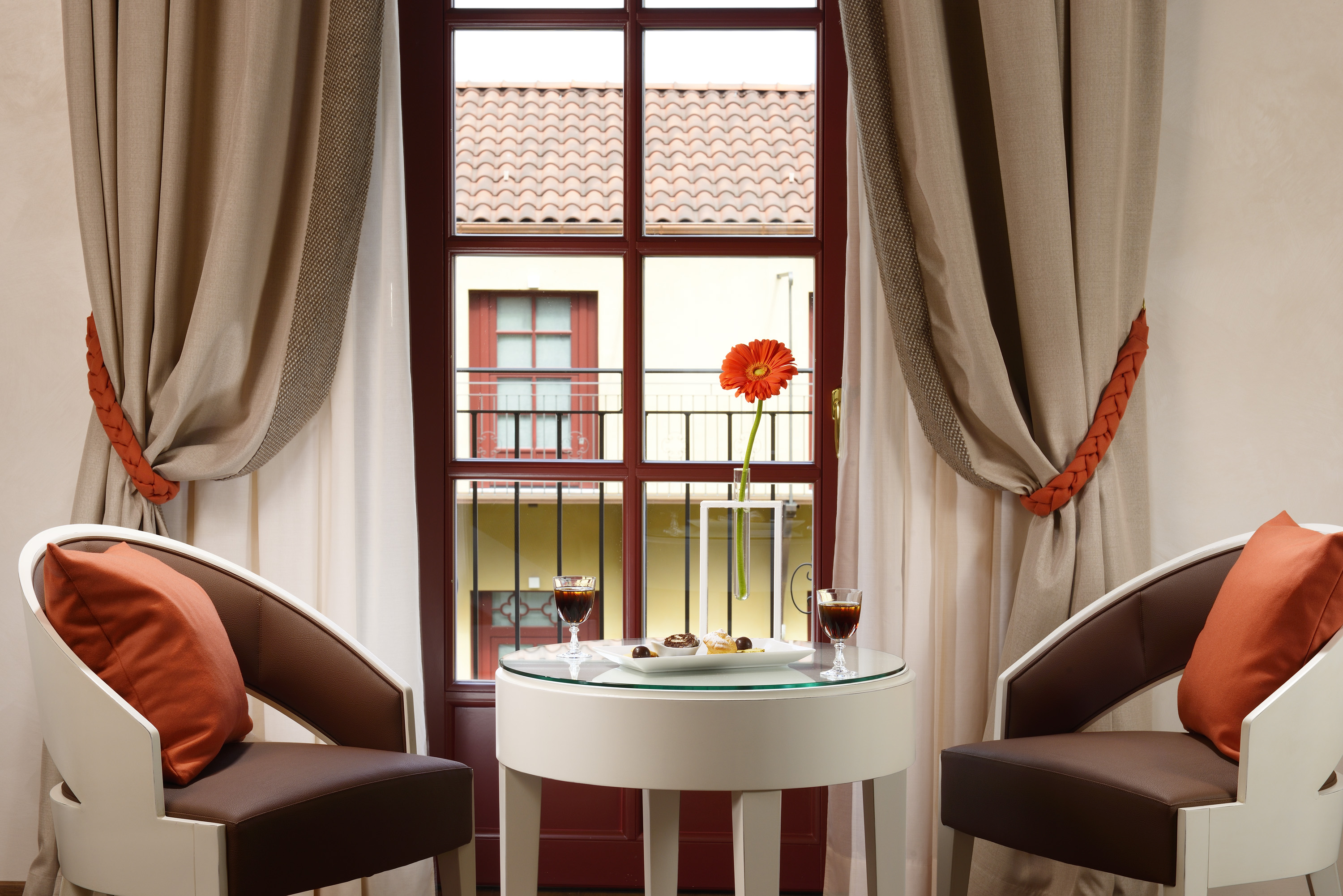 a table with food on it and two chairs in front of a window