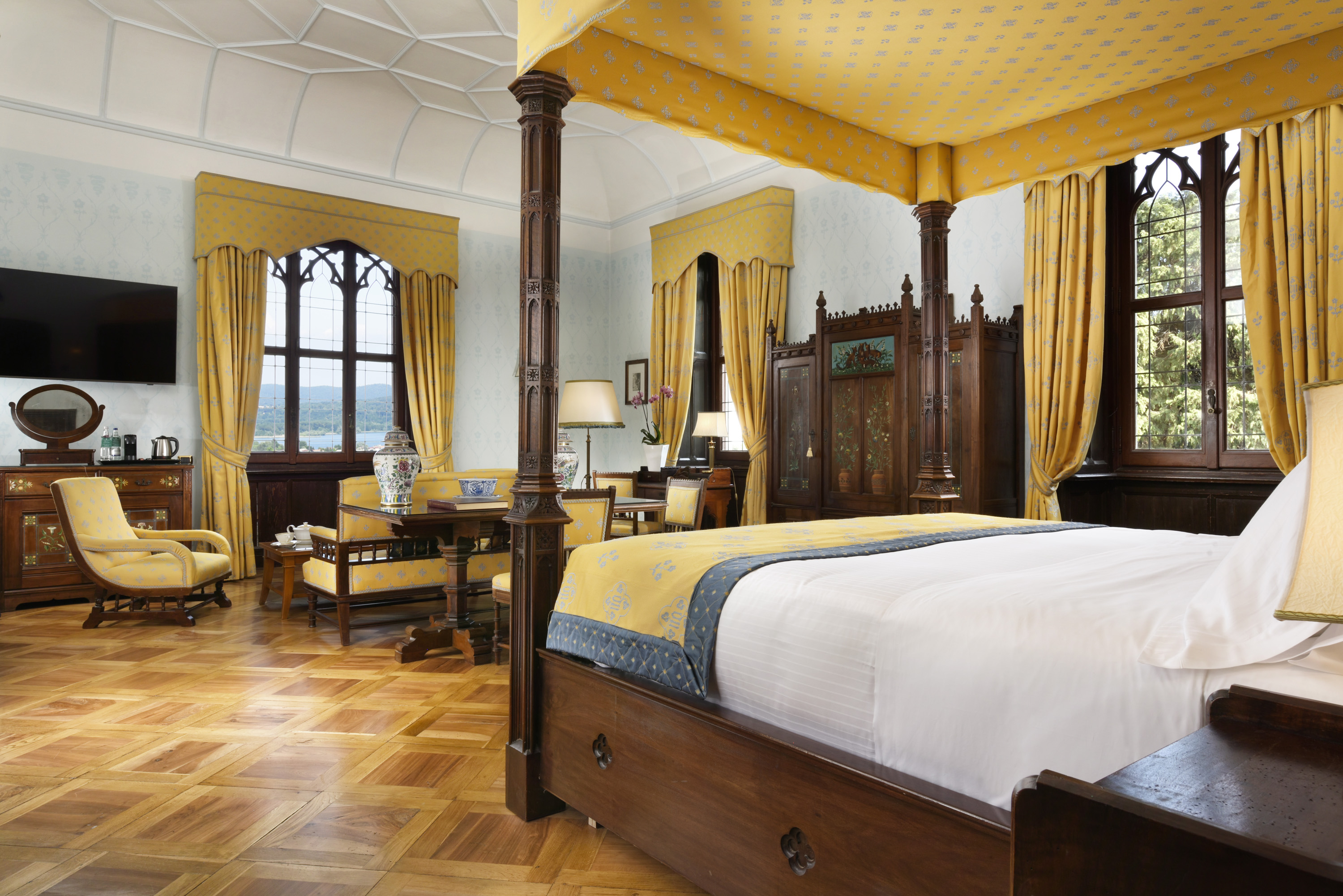 a room with a bed and yellow curtains