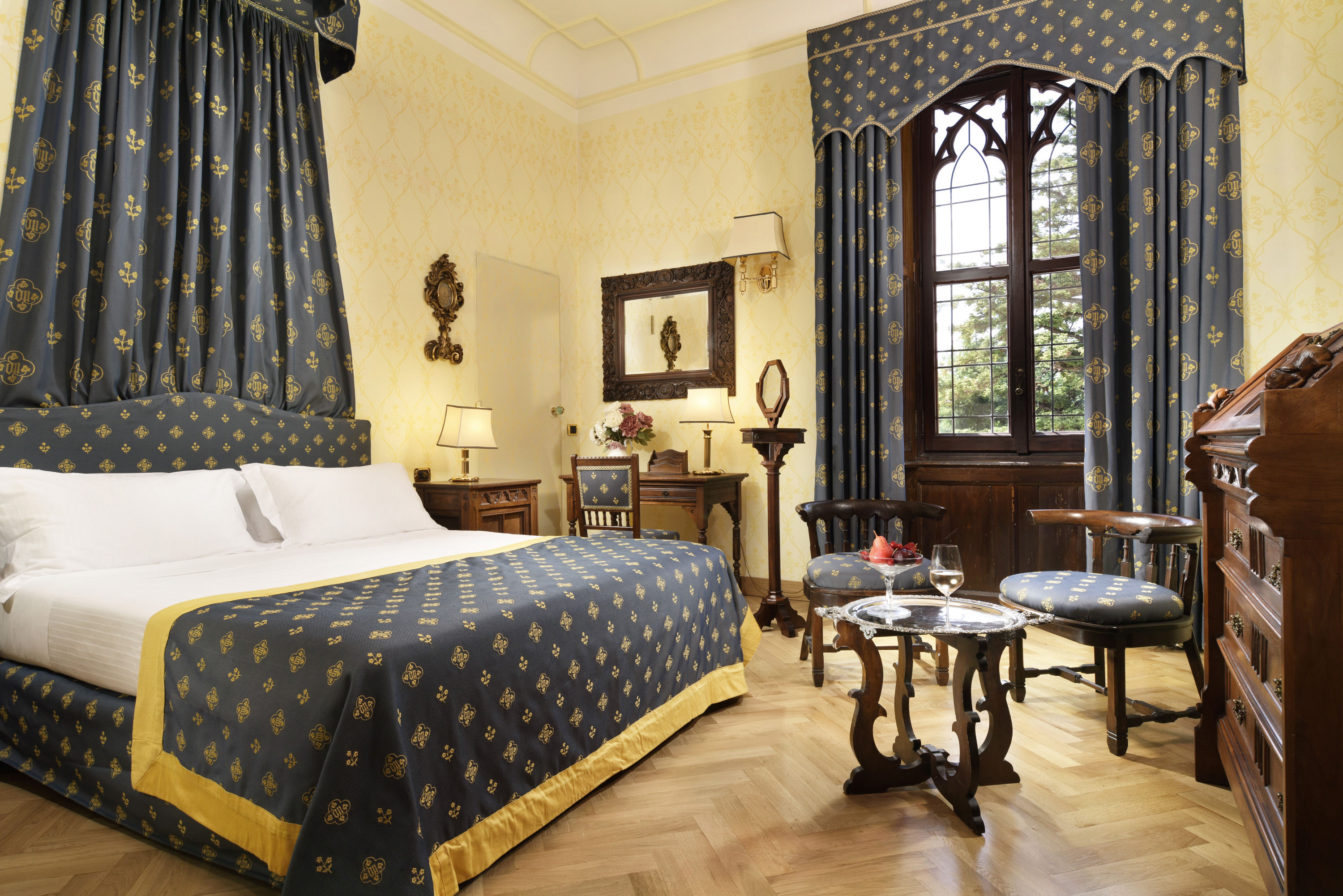 a room with a bed and chairs