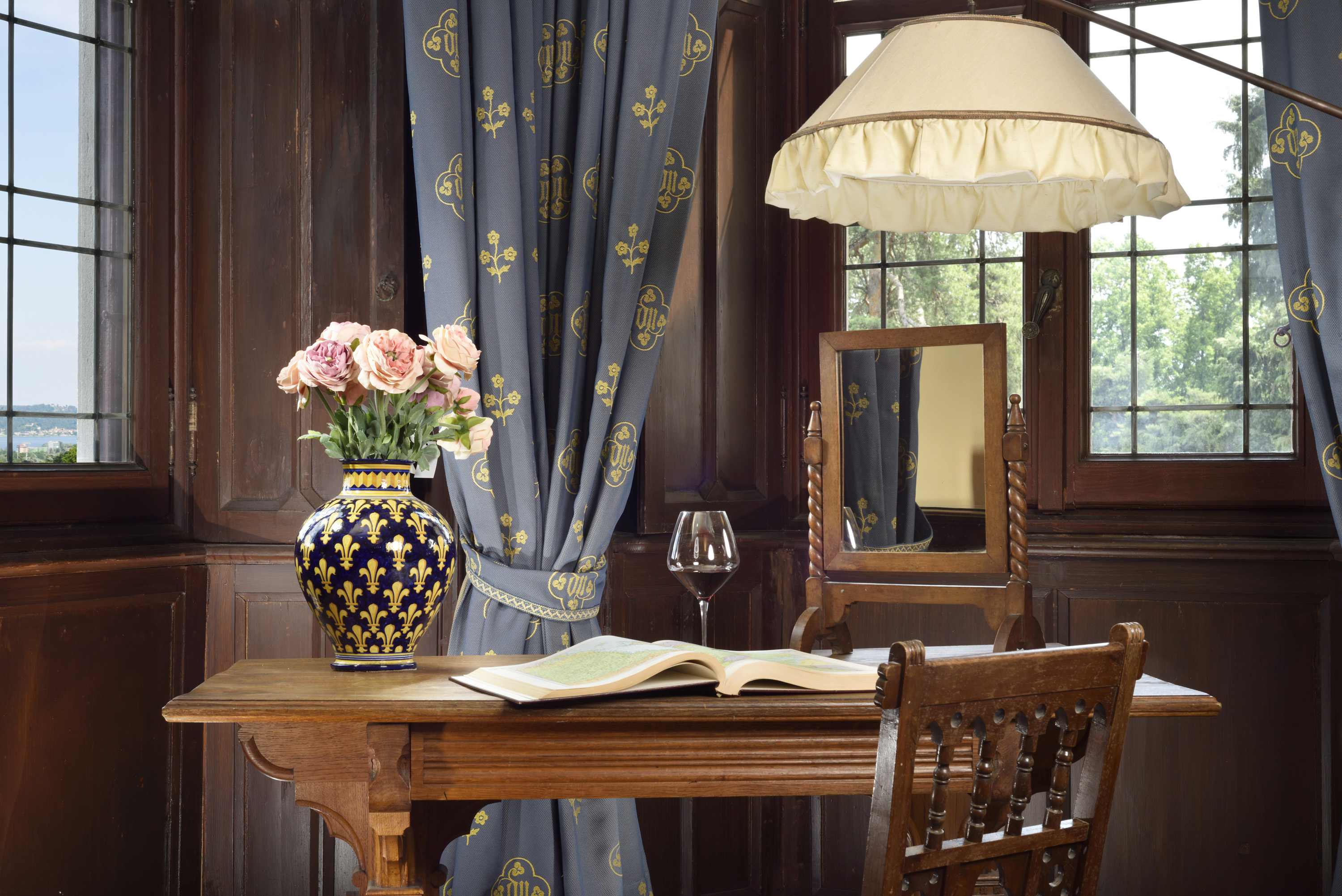 a table with a vase of flowers and a book on it