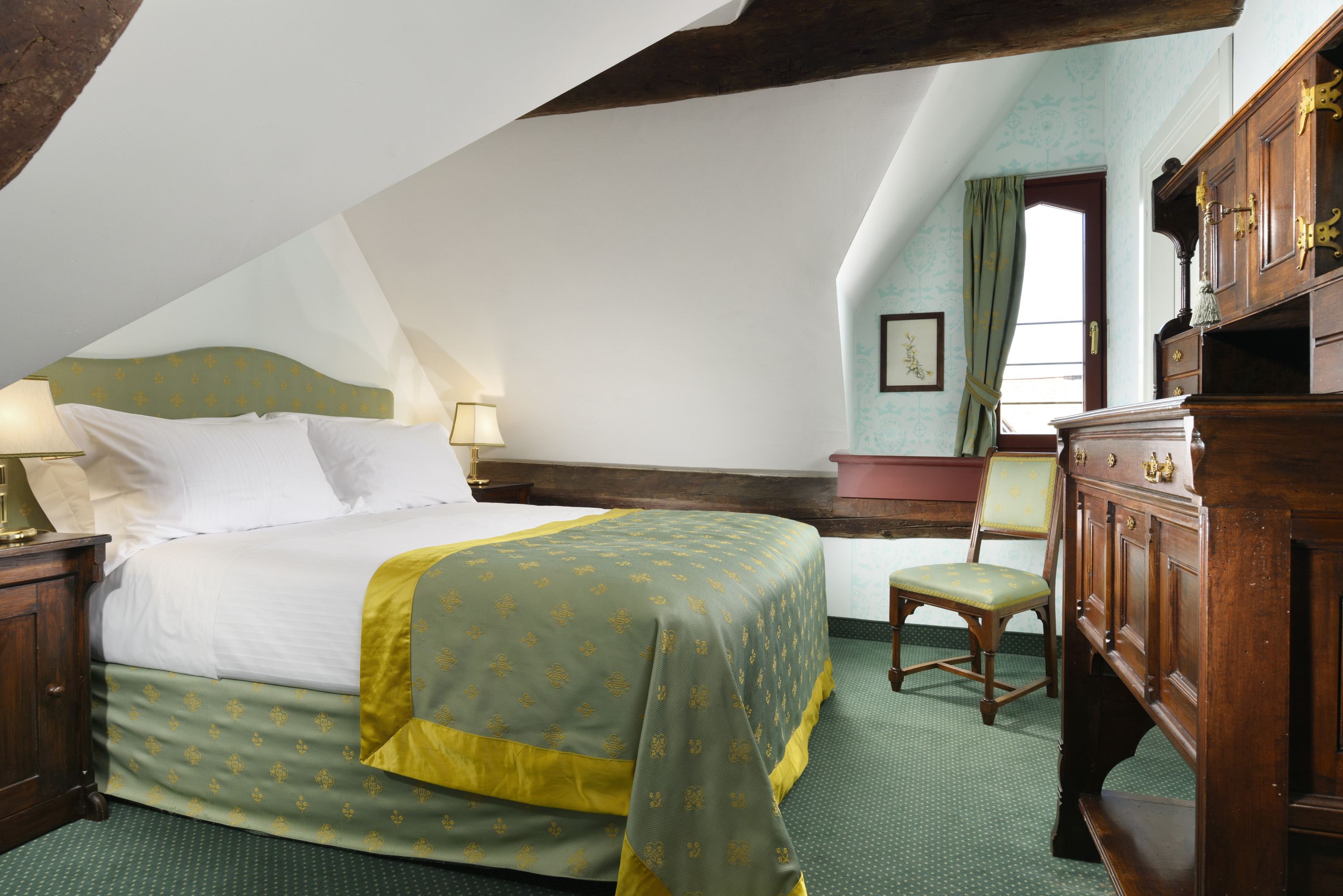 a bedroom with a bed and a chair