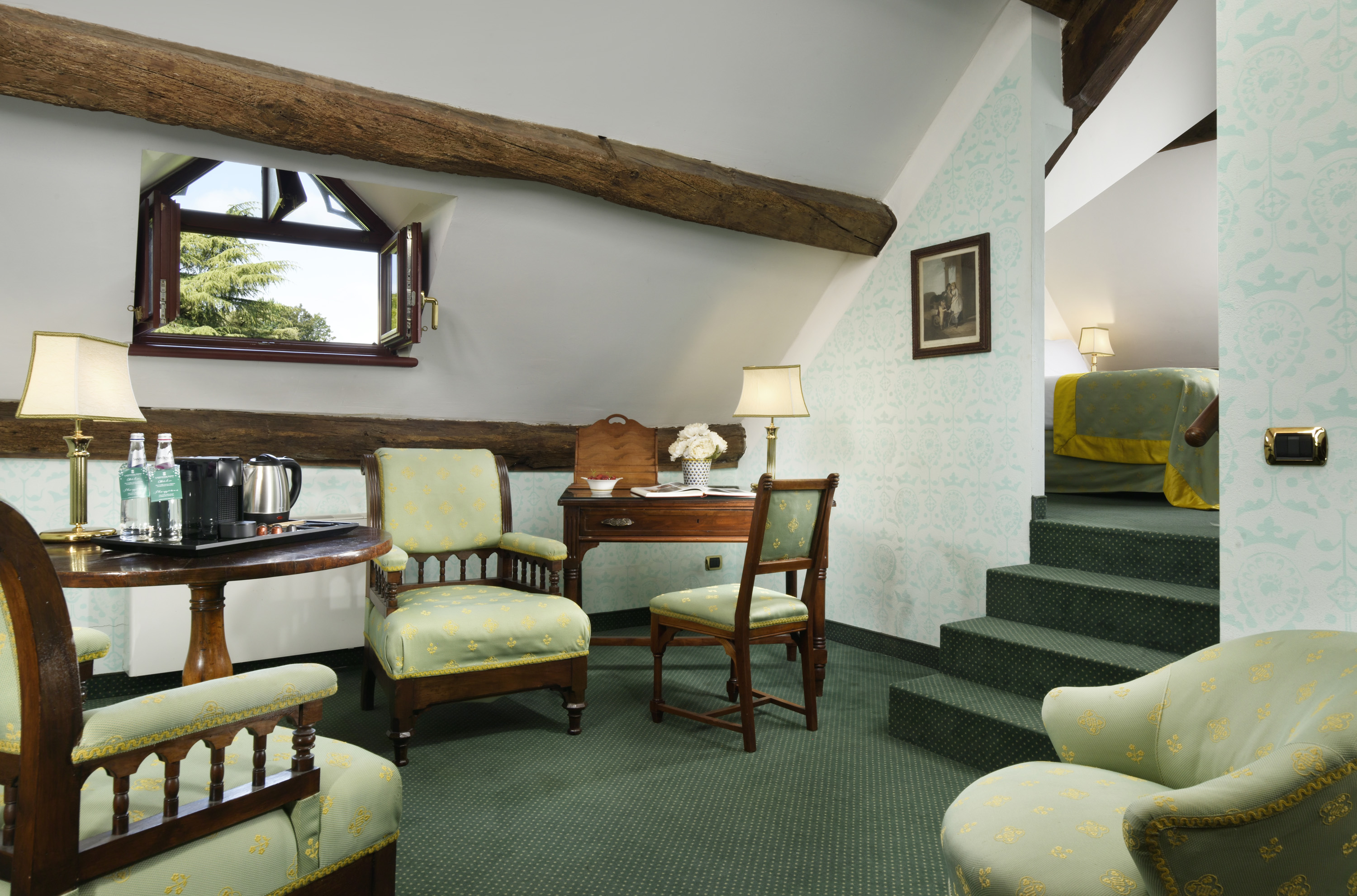 a room with green carpet and green chairs