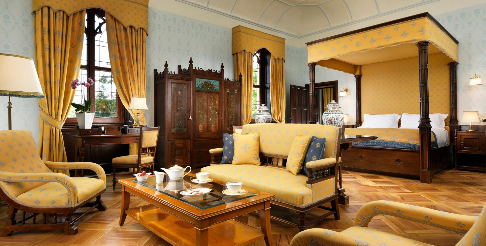a room with yellow furniture and a table