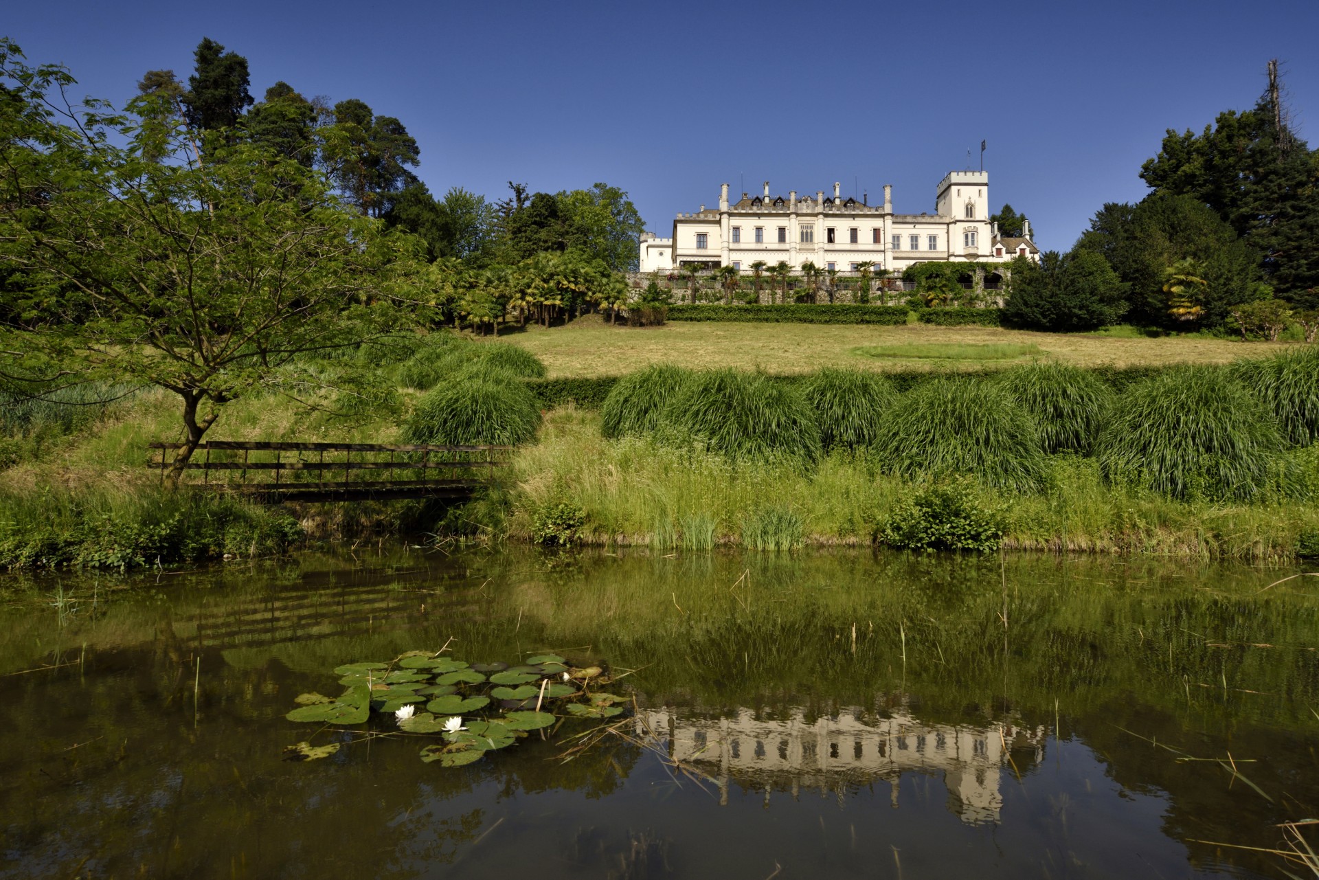 a white building next to a pond