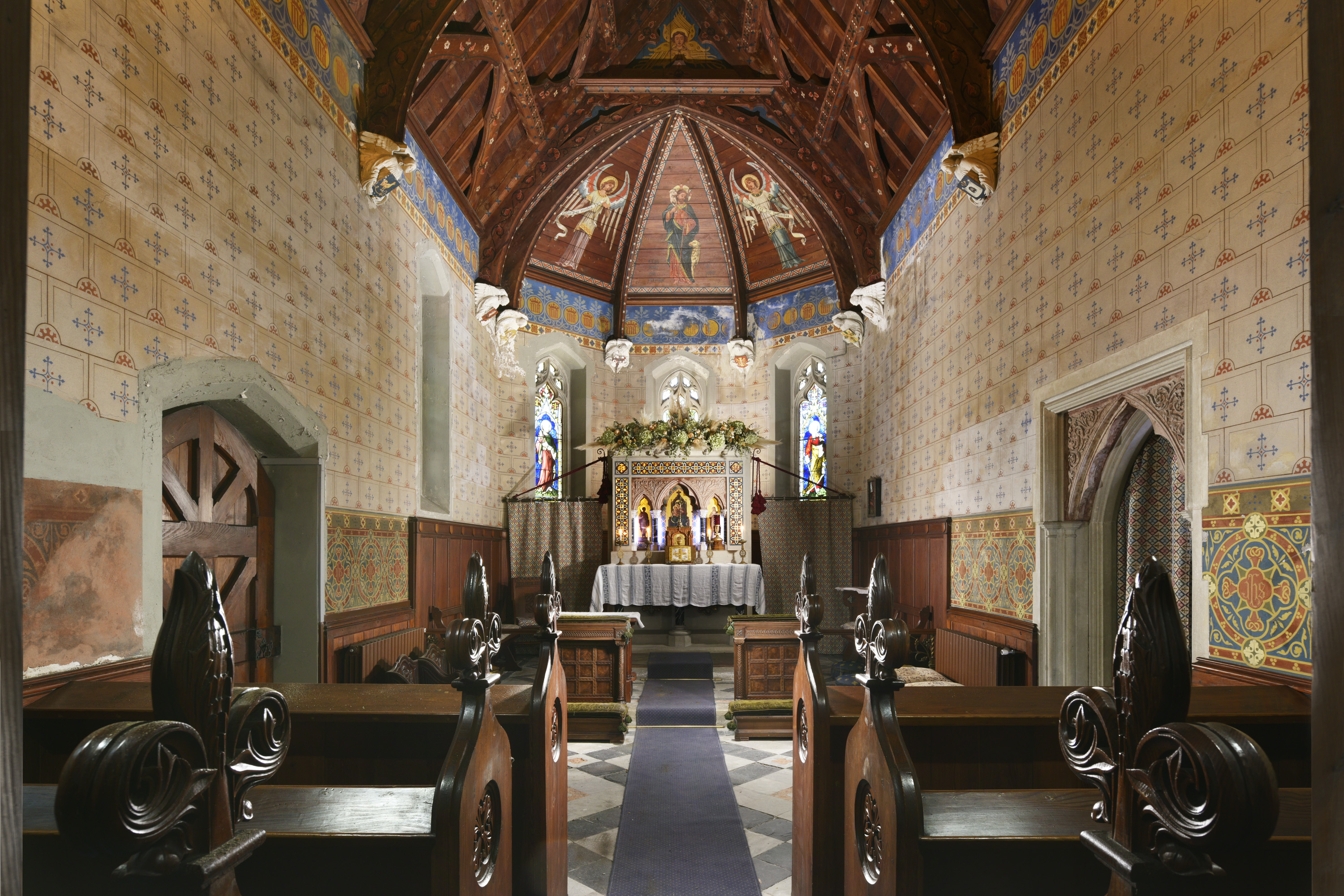 inside a church with a stained glass window